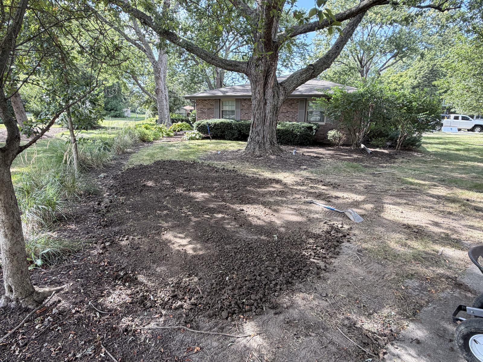 Freshly placed and shaped soil on a yard grading job in Champaign, IL — Brohez Trucking LLC