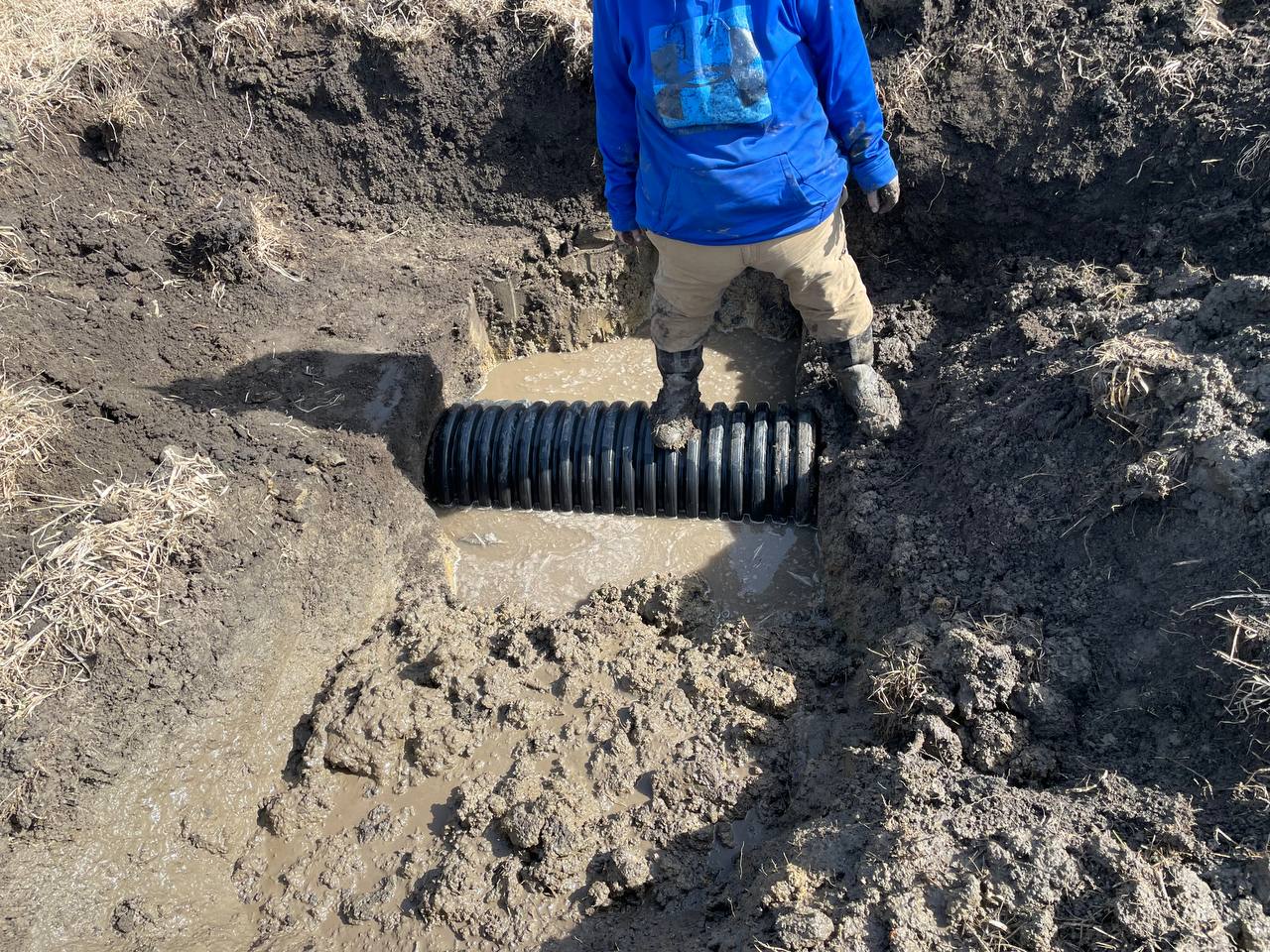 Compacting backfill over new culvert — Brohez Trucking