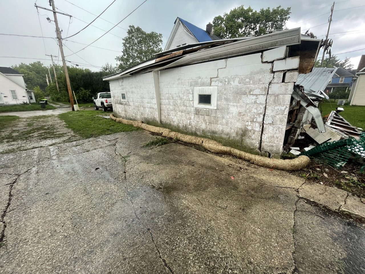 Failing block garage with a collapsed roof awaiting teardown in central Illinois — Brohez Trucking LLC