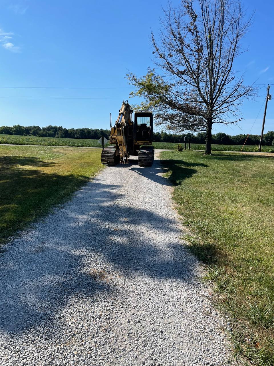 Excavator grading driveway base before stone — Brohez Trucking