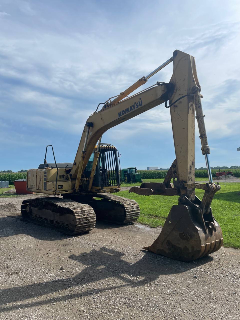 Excavator on sunny pond cleanout day — Brohez Trucking