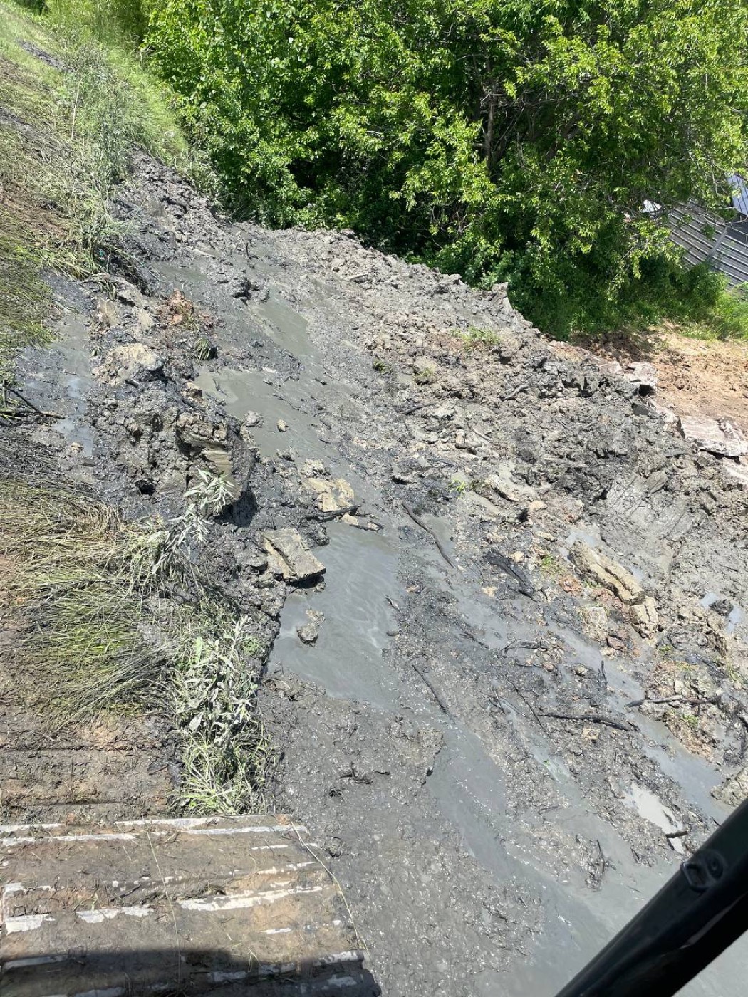 During — Brohez Trucking excavator dredging muck and spoil out of a pond basin in central Illinois