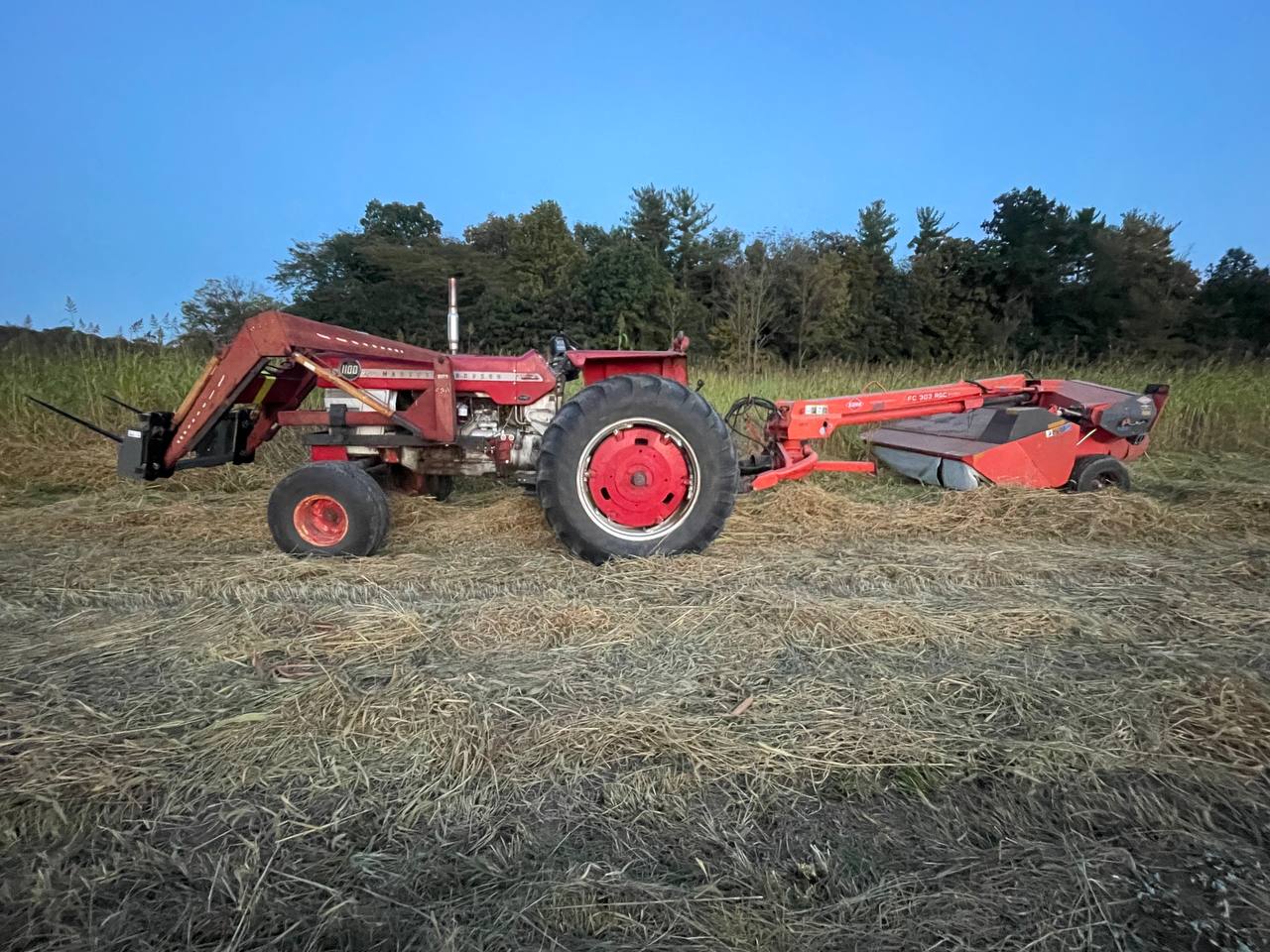 Massey tractor mowing after land clearing — Brohez Trucking